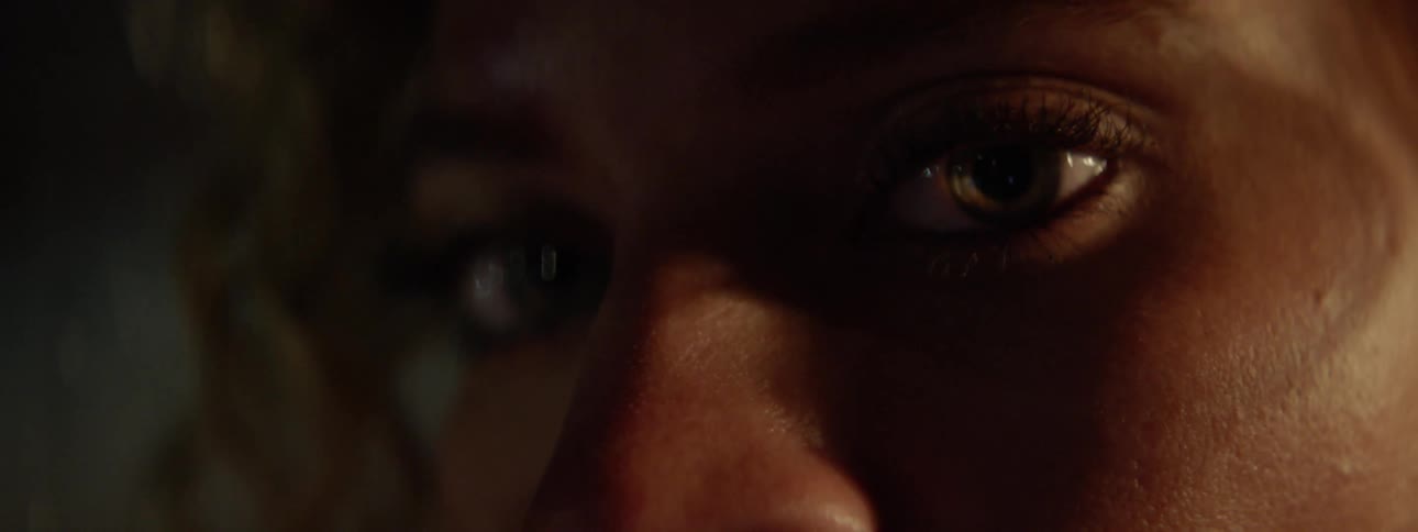 Woman blinks her eyes and stares forward