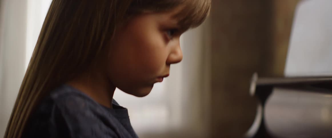 Young girl practices piano