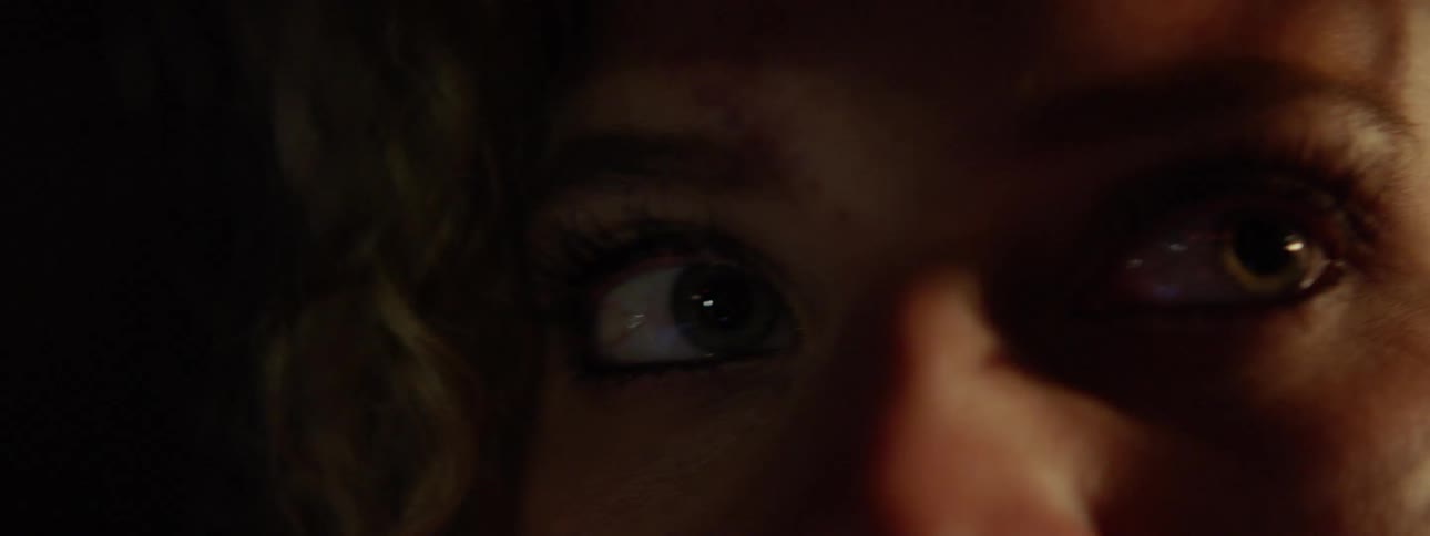 Woman looks around in the dark