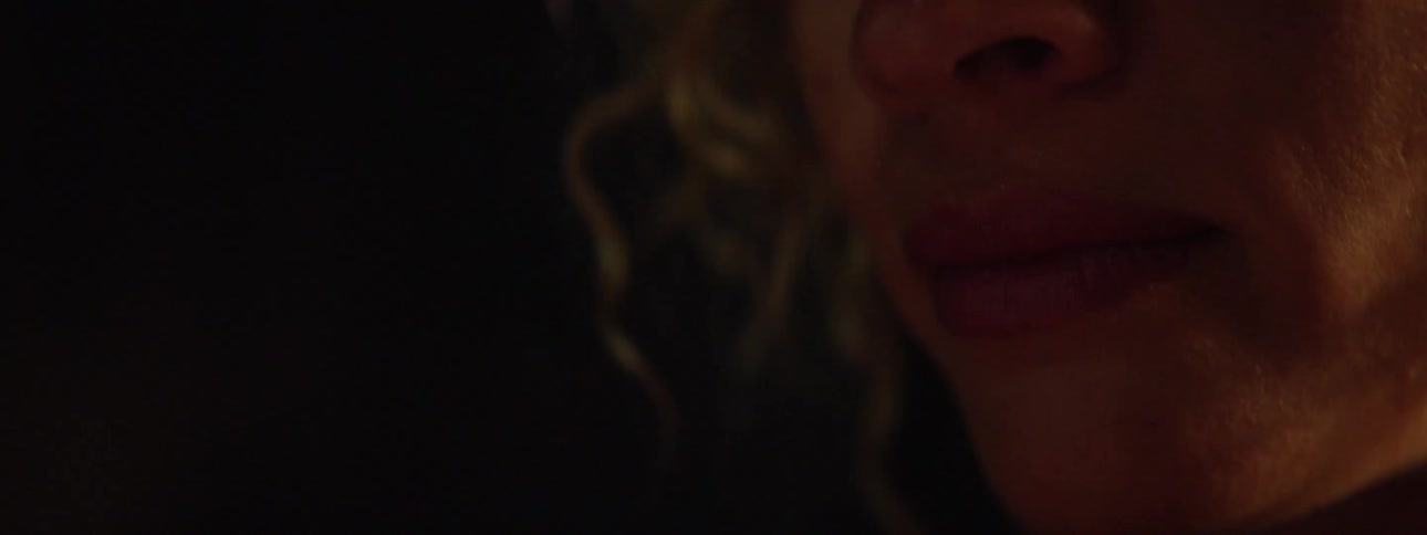 Woman wipes tears from her eye