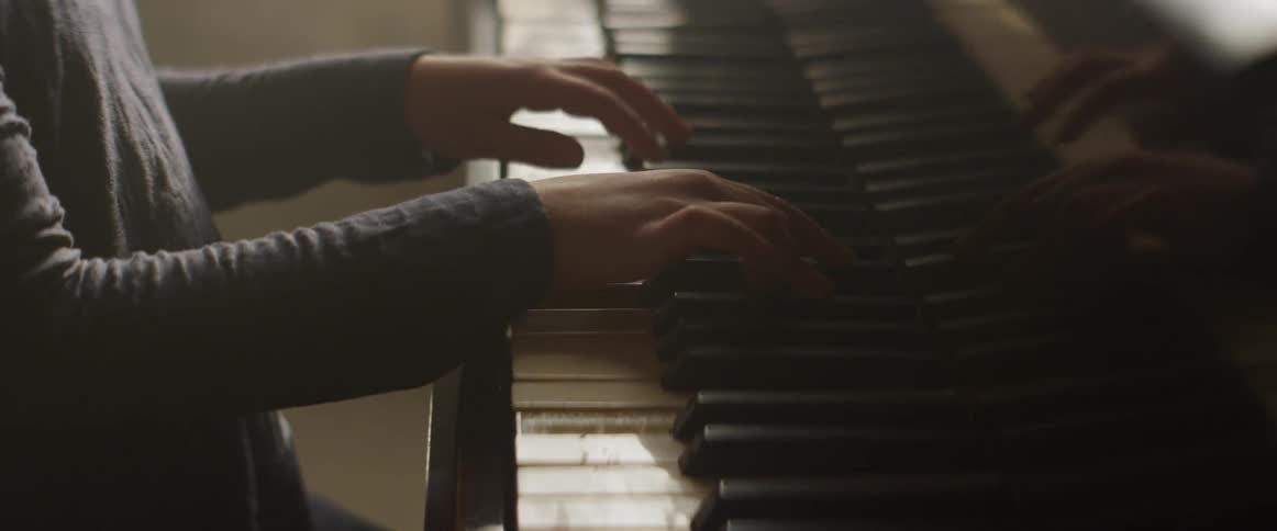 A girl plays a piano