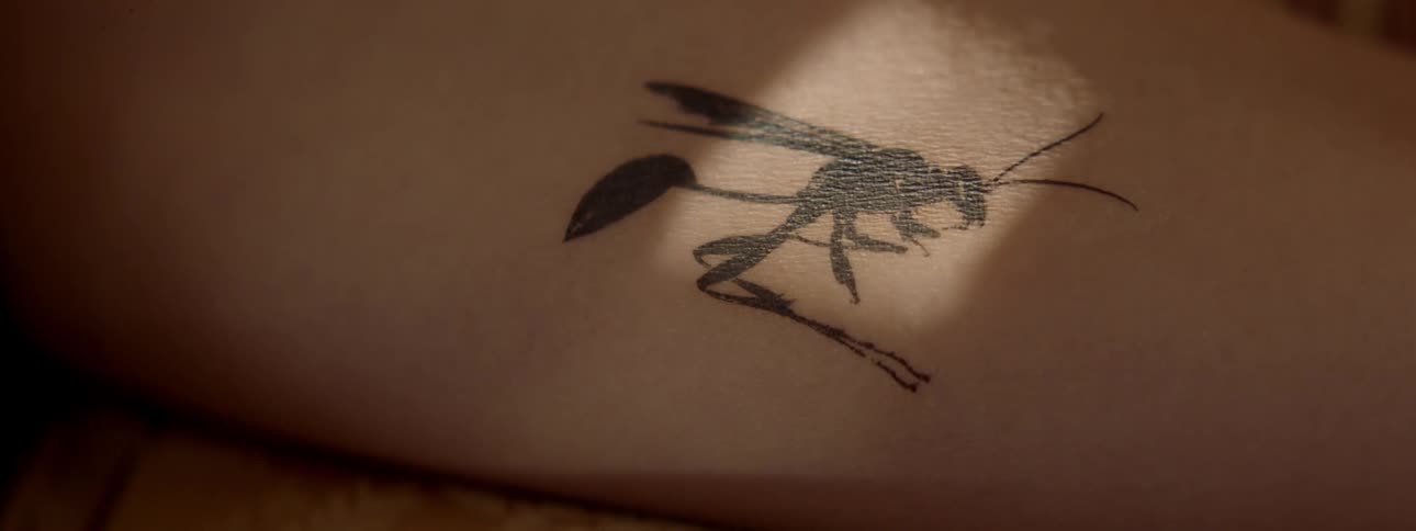 The person is a tattoo of a bug
