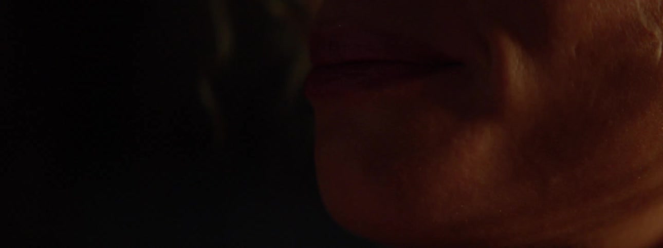 A person is talking in a dark room