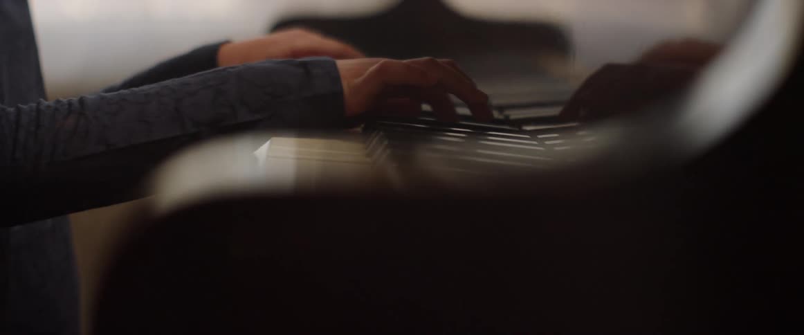Child practices piano during the day