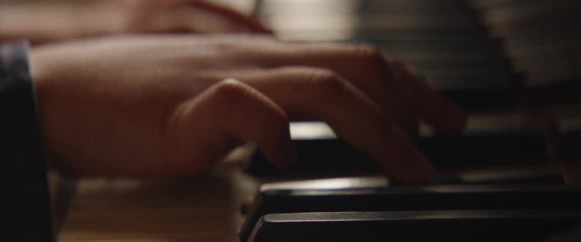 A person is playing the piano slowly