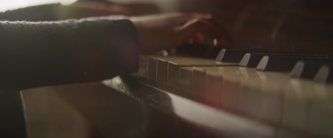 Young girl playing a piano indoors