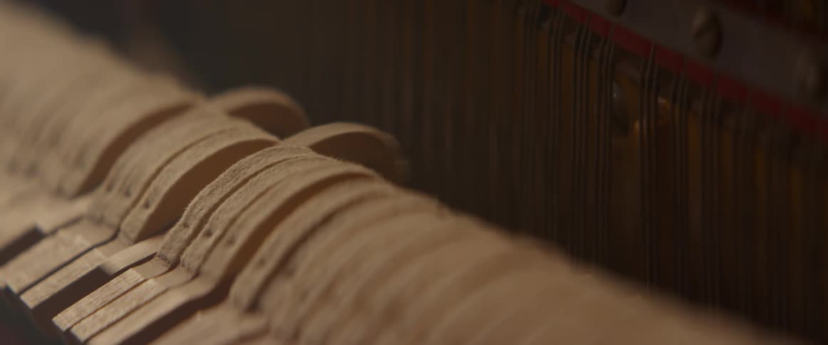 The hammers inside of a piano strike the strings