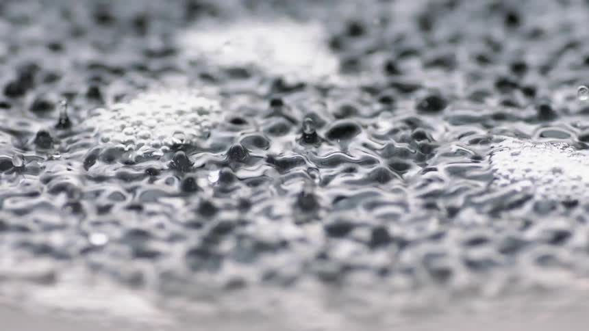 Liquid forms peaks and bubbles as it vibrates
