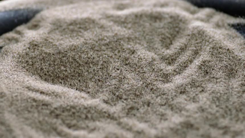 Sand bouncing on a speaker