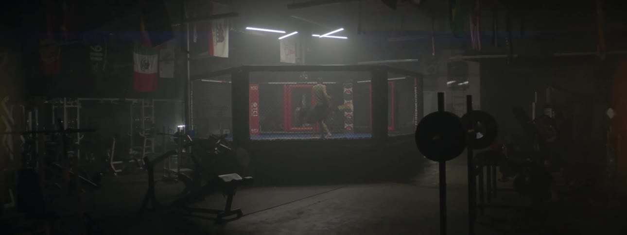 Two men fight in a boxing ring