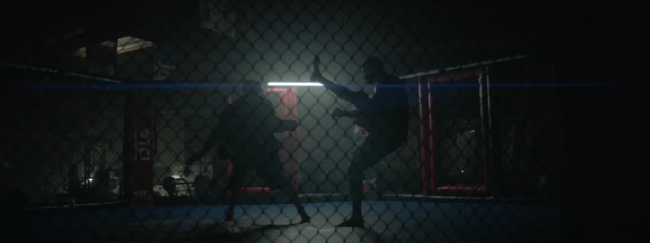 Two men fight in a fighting ring