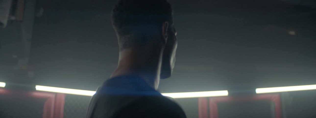 A man stands and sweats in a gym