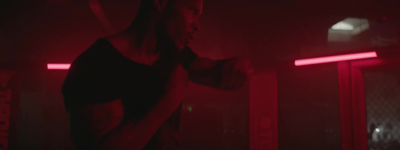 A fighter is shadow boxing in a gym