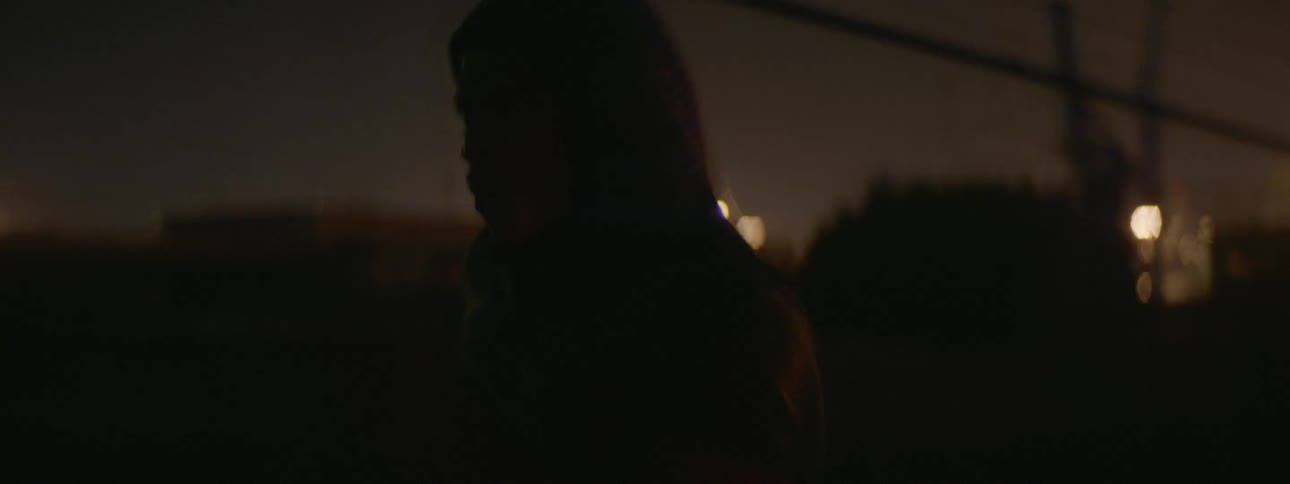 A man is running fast through the city at night