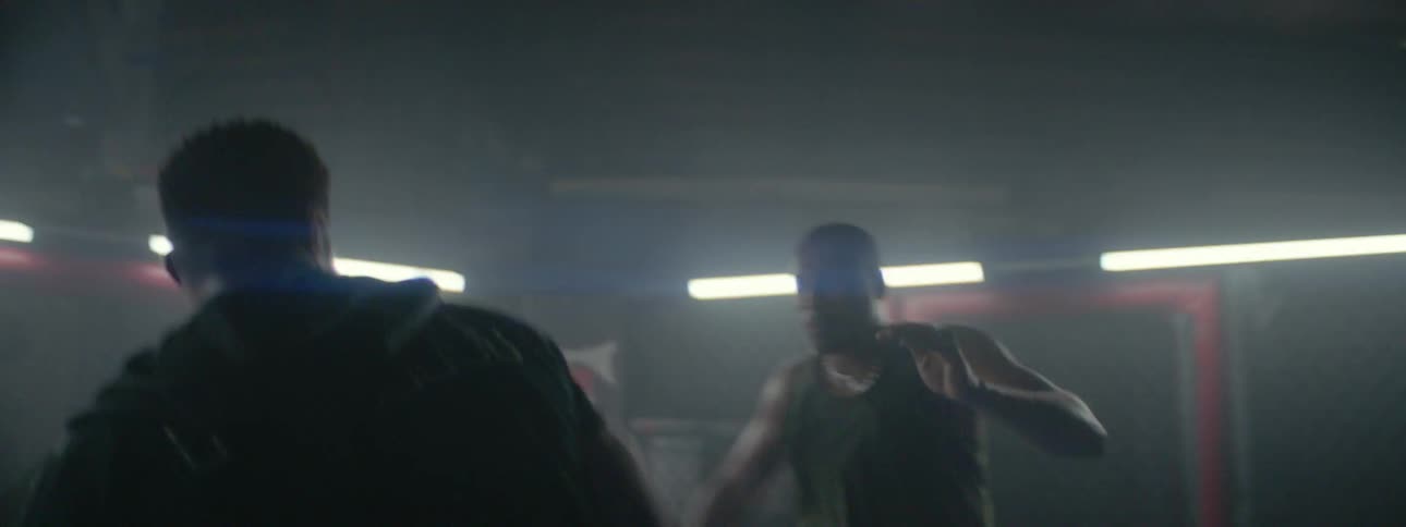 Two men spar in a mixed martial arts ring