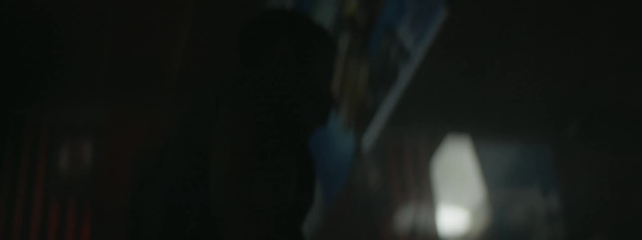 A man trains in a gym with flashing lights