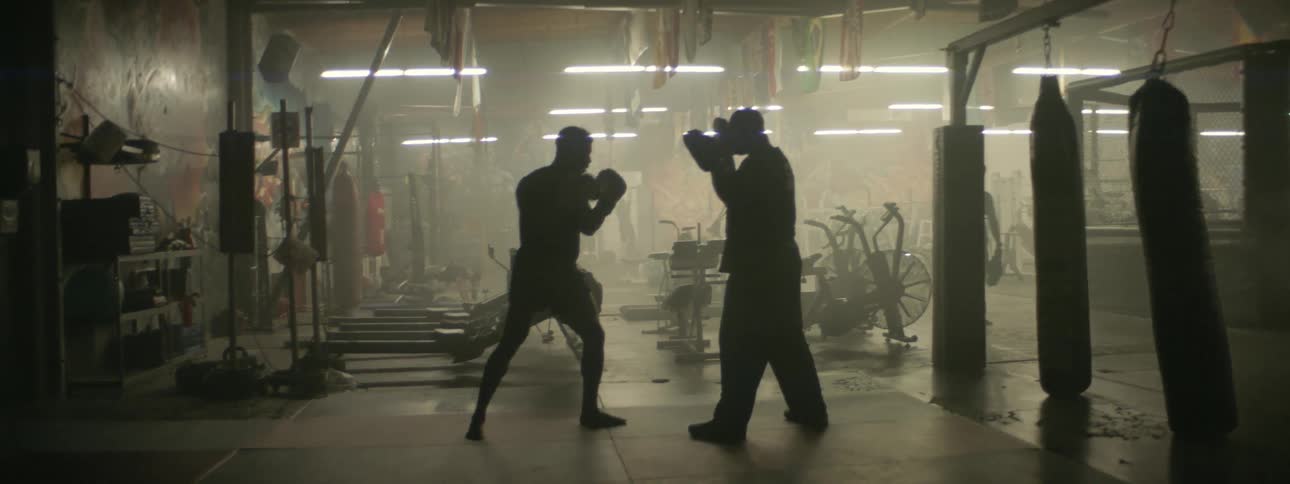 A boxer practices in the dark gym