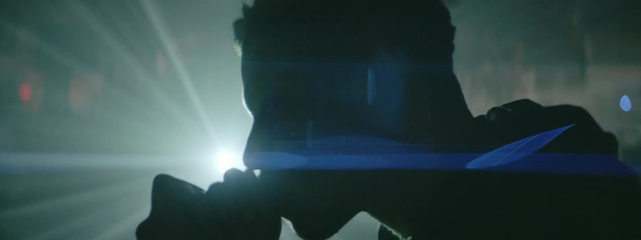 A man sits deep in thought as a light shines on him