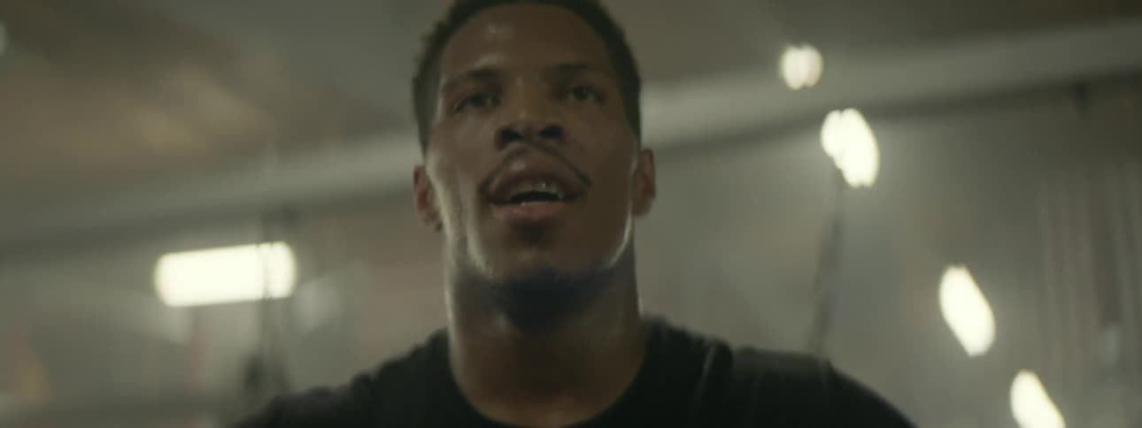 A man catches his breath at the gym