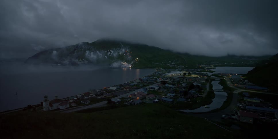 Fireworks explode next to a coastal community