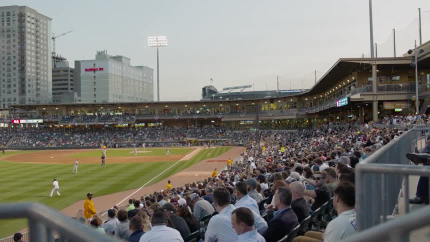 People watch as the baseball players perform