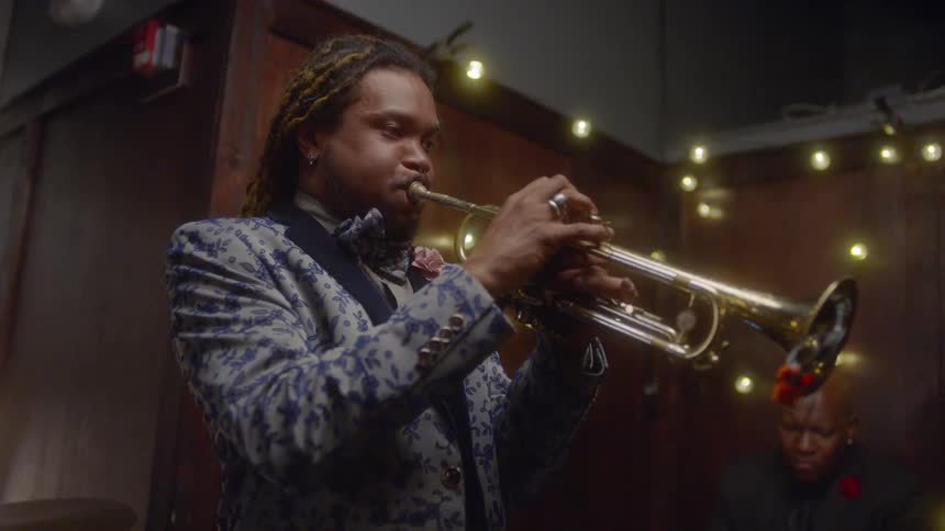 A musician plays a trumpet with a band