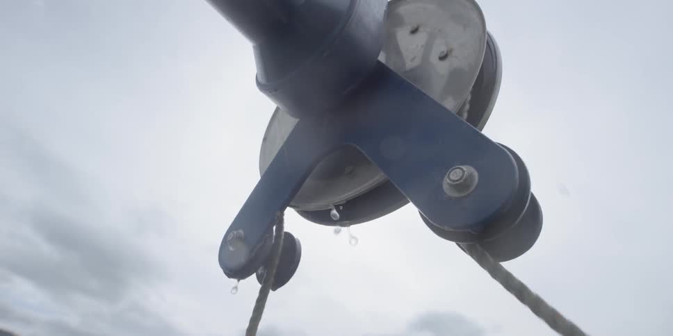 A winch is pulling a rope out of the water