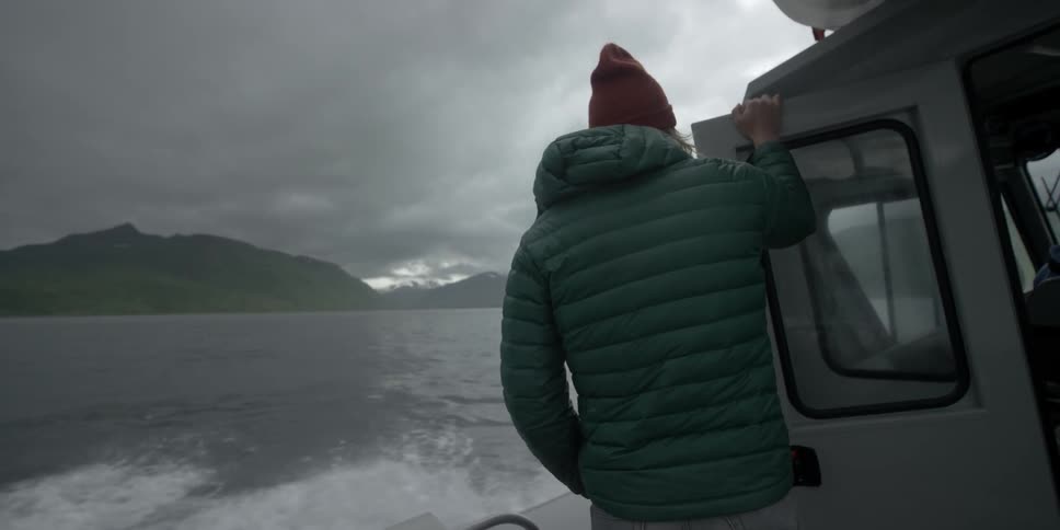 Person riding on boat on cloudy evening