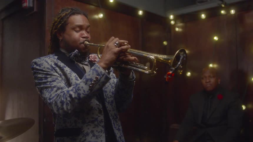A man in a band plays the trumpet