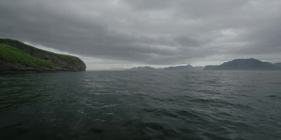 Waves flow in the water under overcast skies