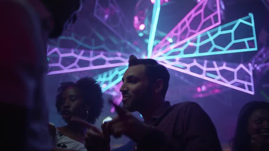 Men and women are dancing in a club at night