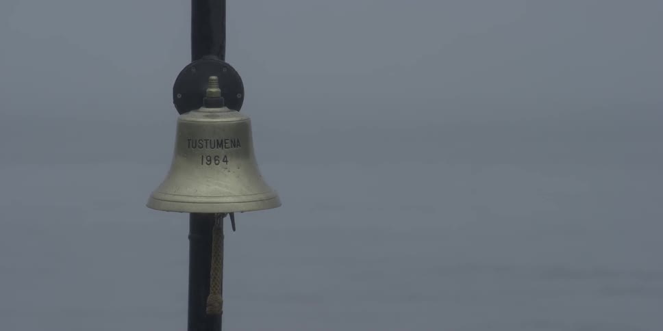 A rope attached to a bell sways in the breeze
