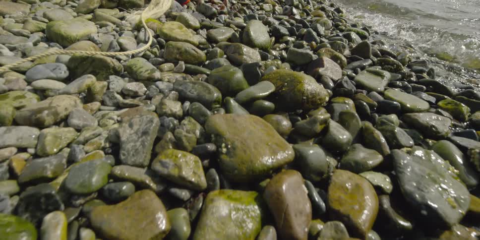 Water flows over rocks on the edge of the coast