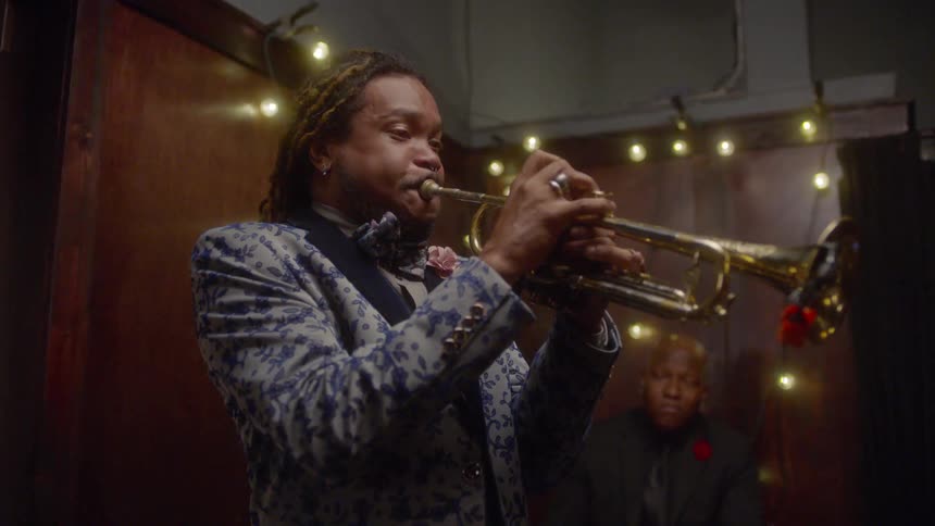 A man is playing the sax while another man is playing a keyboard