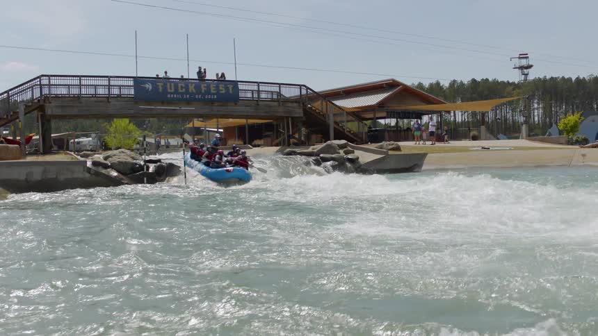 People white water raft in flowing rapids