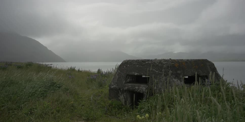 An abandoned structure sits next to the ocean