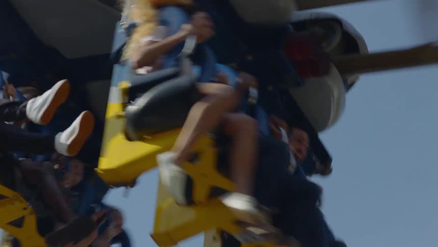 An amusement park roller coaster is full of passengers