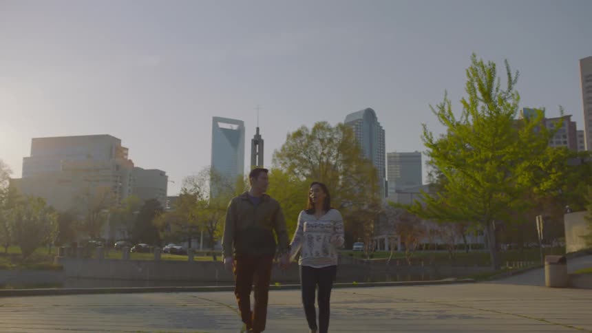 A man and woman walk through a path in the center of the city
