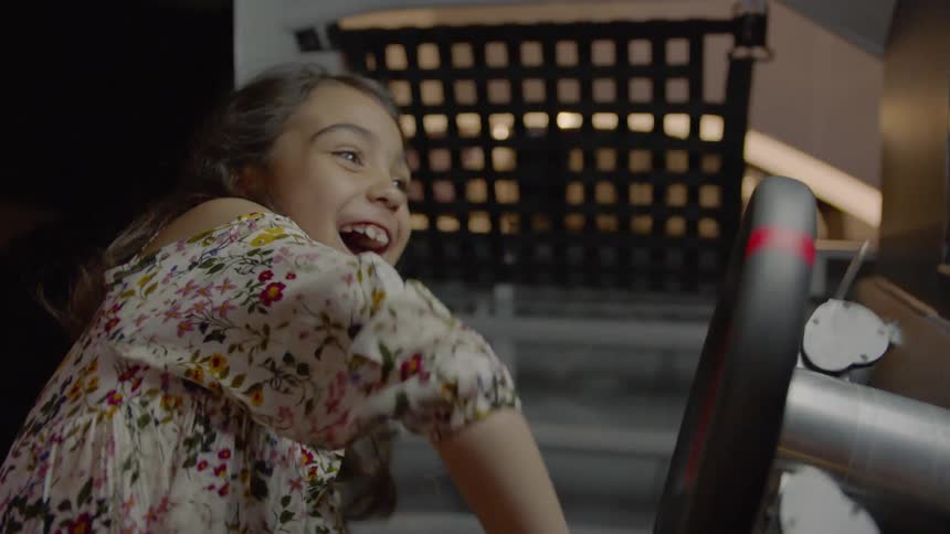 A girl is having fun steering a wheel