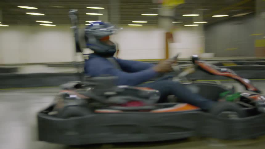 A person drives a bumper car around a track