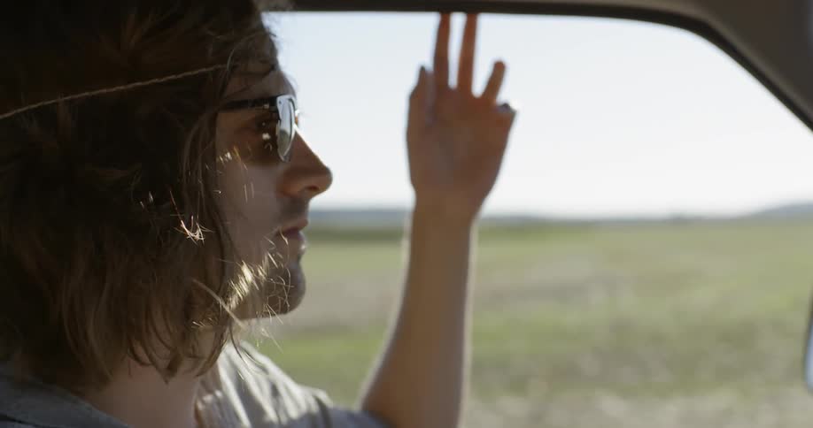 A man drives during the day