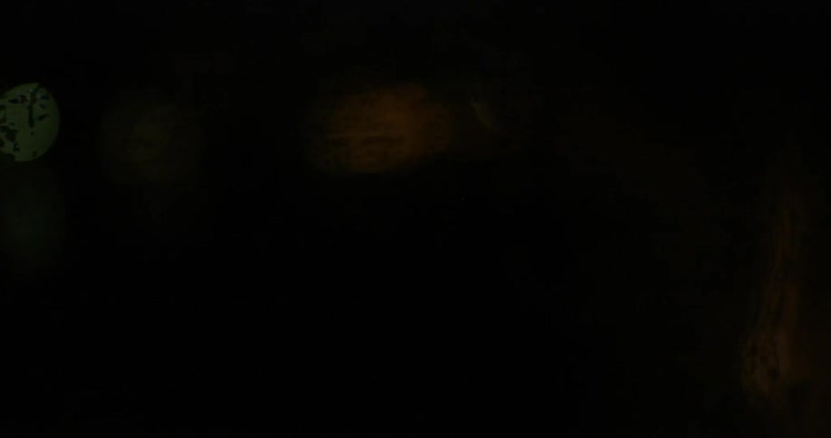 Light shines on beaded water on a window