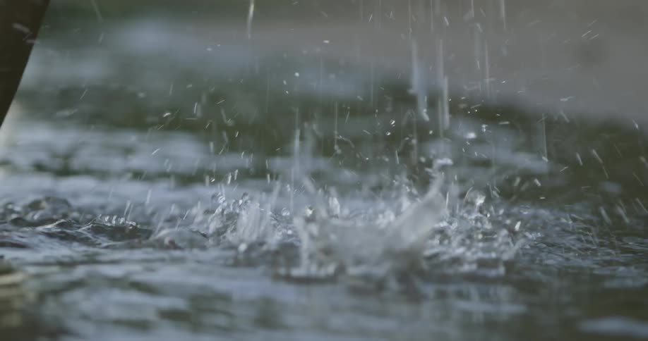 A person walks out of the water causing drips and splashes