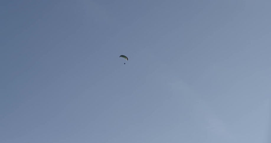 The paraglider soars through the air