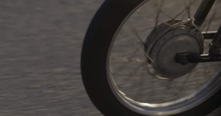 A bike is driven on asphalt