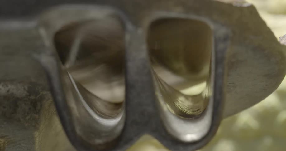 Objects pass above two steel channels
