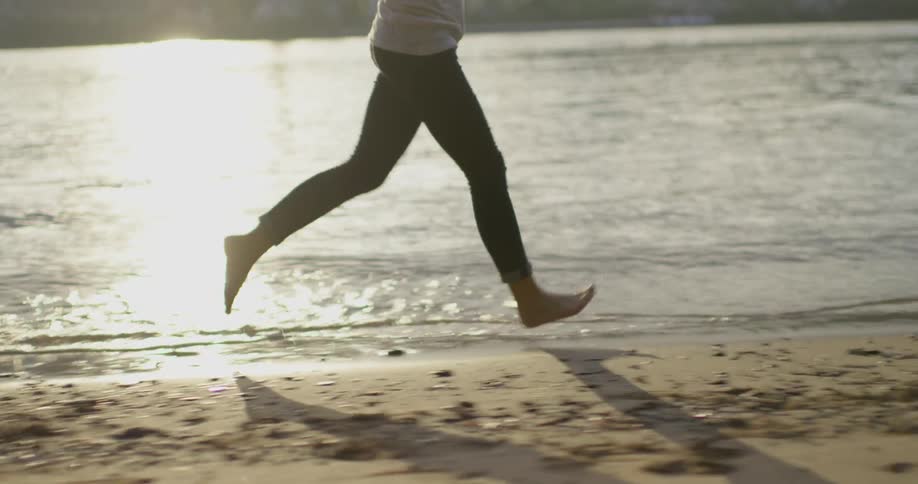 A woman runs along the shore