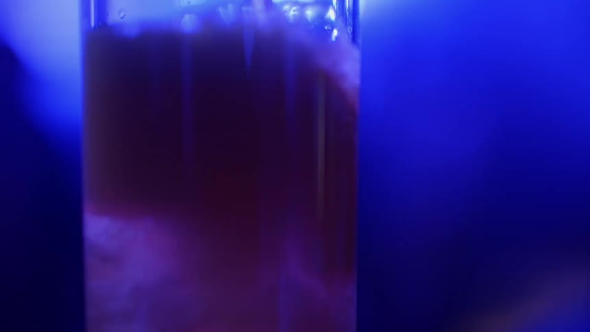 Liquid is poured over ice in a glass then drains away