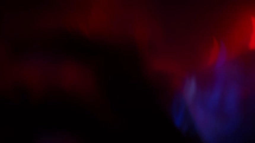 Colored lights shine and glow around silhouettes of people