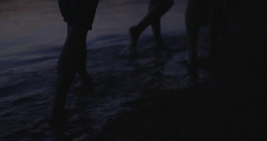 People walk through shallow water